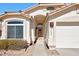 The front entry of this single-story home showcases desert landscaping, and a two-car garage at 6408 W Prickly Pear Trl, Phoenix, AZ 85083