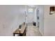 Inviting hallway with neutral tones, tiled floor, and a view of the front door at 6408 W Prickly Pear Trl, Phoenix, AZ 85083