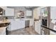 Stylish kitchen with white cabinets, stainless steel dishwasher, and gray countertop at 6408 W Prickly Pear Trl, Phoenix, AZ 85083