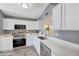 Modern kitchen featuring white cabinets, stainless steel appliances, and sleek countertops at 6408 W Prickly Pear Trl, Phoenix, AZ 85083