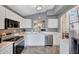 Bright kitchen with white cabinets, stainless steel appliances, and modern lighting at 6408 W Prickly Pear Trl, Phoenix, AZ 85083