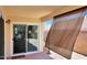 Covered patio with sliding glass door and outdoor shade screen at 6408 W Prickly Pear Trl, Phoenix, AZ 85083