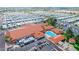 An aerial view showcasing the recreational pool, large club house, and dense community of residences at 650 N Hawes Rd # 2873, Mesa, AZ 85207