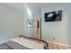 Light-blue bedroom with tiled floors, a TV, and a mirror and door in the background at 650 N Hawes Rd # 2873, Mesa, AZ 85207