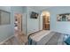 Charming bedroom with cool blue walls, TV, and bathroom entrance with a sink and vanity at 650 N Hawes Rd # 2873, Mesa, AZ 85207