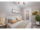 Cozy bedroom featuring a door to the outside, decorative pillows, and stylish wall art at 650 N Hawes Rd # 2873, Mesa, AZ 85207