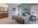 Serene bedroom with light-blue walls, stylish decor, and an en-suite bathroom with coordinated vanity at 650 N Hawes Rd # 2873, Mesa, AZ 85207