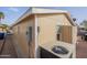 The exterior showcases the air conditioning and a brick paved side yard at 650 N Hawes Rd # 2873, Mesa, AZ 85207