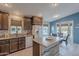 Modern kitchen with dark wood cabinets, stone countertops, and stainless steel appliances at 650 N Hawes Rd # 2873, Mesa, AZ 85207