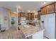 Well appointed kitchen features a center island with granite countertops and ample storage space at 650 N Hawes Rd # 2873, Mesa, AZ 85207