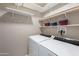 The laundry room includes white shelving and a washer and dryer with hookups at 650 N Hawes Rd # 2873, Mesa, AZ 85207