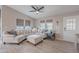 Bright living room with a ceiling fan, neutral colored walls, and lots of natural light at 650 N Hawes Rd # 2873, Mesa, AZ 85207