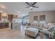 Open-concept living room, kitchen with stylish countertops, and dining area with abundant natural light at 650 N Hawes Rd # 2873, Mesa, AZ 85207