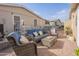 This inviting outdoor patio offers ample seating with comfortable wicker furniture and brick pavers at 650 N Hawes Rd # 2873, Mesa, AZ 85207