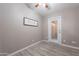 Simple yet modern room with tiled floors, ceiling fan, and access to the backyard at 650 N Hawes Rd # 2873, Mesa, AZ 85207