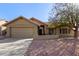 Charming single-story home with a two-car garage and mature landscaping in front yard at 6551 E Quartz St, Mesa, AZ 85215