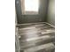 A small bedroom with gray walls, light-colored trim, laminate flooring, and a window at 6607 W Osborn Rd, Phoenix, AZ 85033