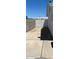 Cement driveway leading to a white wooden fence and gate, and a block wall fence at 6607 W Osborn Rd, Phoenix, AZ 85033