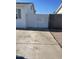 Concrete driveway leads to white wood fence and gate, and a block wall fence at 6607 W Osborn Rd, Phoenix, AZ 85033