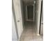 A hallway view of tile flooring, a ceiling light fixture, and several white doors at 6607 W Osborn Rd, Phoenix, AZ 85033