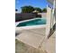Backyard pool featuring a diving board, lounge area, and block fence for added privacy at 6607 W Osborn Rd, Phoenix, AZ 85033
