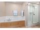 A bathtub and a glass enclosed shower are featured in this bathroom at 6803 E Main St # 3306, Scottsdale, AZ 85251
