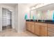 Double sinks and a large mirror highlight the bathroom, next to the walk-in closet at 6803 E Main St # 3306, Scottsdale, AZ 85251