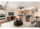 Open-concept living room features a breakfast bar, kitchen, and modern entertainment center at 6803 E Main St # 3306, Scottsdale, AZ 85251