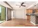 Open living space with hardwood-style flooring, a view of the modern kitchen, and neutral paint at 6803 E Main St # 3306, Scottsdale, AZ 85251