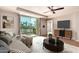 Inviting living room boasts a sliding glass door, ceiling fan, and modern furniture at 6803 E Main St # 3306, Scottsdale, AZ 85251