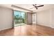 Bright living room with a ceiling fan, sliding glass door, and hardwood-style floors at 6803 E Main St # 3306, Scottsdale, AZ 85251