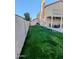 A backyard with green grass and a covered patio seating area ideal for outdoor entertaining at 6901 W Marco Polo Rd, Glendale, AZ 85308
