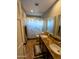 Bathroom featuring double vanity sinks with granite countertops and tile flooring at 6901 W Marco Polo Rd, Glendale, AZ 85308