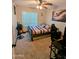 Cozy bedroom featuring carpet floors, a ceiling fan, a window, and a gaming setup at 6901 W Marco Polo Rd, Glendale, AZ 85308