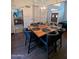 Dining area features stylish wood table with seating for six, modern lighting, and wood flooring at 6901 W Marco Polo Rd, Glendale, AZ 85308