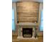 Close up of fireplace features brick surround, wooden mantle, and tile hearth at 6901 W Marco Polo Rd, Glendale, AZ 85308