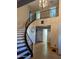 Spacious foyer with a curved staircase, chandelier and decorative wall art at 6901 W Marco Polo Rd, Glendale, AZ 85308