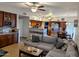 Open-concept living area with kitchen view features a large sectional sofa and fireplace at 6901 W Marco Polo Rd, Glendale, AZ 85308