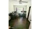 Office with two desk areas, hardwood floors, and sliding door closet at 6901 W Marco Polo Rd, Glendale, AZ 85308