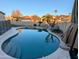 The backyard has a private in-ground pool, palm trees, and a rock feature for relaxing outdoor enjoyment at 6901 W Marco Polo Rd, Glendale, AZ 85308