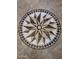 Close up of a tile inlay in the foyer of the home, with a starburst design at 6901 W Marco Polo Rd, Glendale, AZ 85308