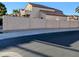 Street view of the side of the house and wall in a suburban neighborhood on a sunny day at 6901 W Marco Polo Rd, Glendale, AZ 85308