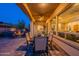 Spacious covered patio with ceiling fan, exterior lounge area with fire pit, and beautiful yard at 706 E La Palta St, Queen Creek, AZ 85140