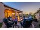 Inviting backyard with a stone fire pit, ample seating, and lush landscaping for outdoor enjoyment at 706 E La Palta St, Queen Creek, AZ 85140