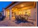 Relaxing covered patio, with arched openings, leads to an outdoor lounge area with fire pit at 706 E La Palta St, Queen Creek, AZ 85140