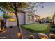 Expansive backyard with a putting green, fire pit, and covered patio, perfect for outdoor living at 706 E La Palta St, Queen Creek, AZ 85140