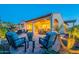 Spacious backyard patio with comfortable seating and a view of the landscaped yard for relaxing and entertaining guests at 706 E La Palta St, Queen Creek, AZ 85140