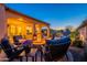 Inviting backyard with outdoor seating around a fire pit and covered patio for relaxation at 706 E La Palta St, Queen Creek, AZ 85140