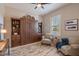 Cozy bedroom featuring a Murphy bed, stylish decor, neutral colors, and natural light from the window at 706 E La Palta St, Queen Creek, AZ 85140