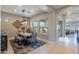 Bright dining room featuring a rustic table, comfortable seating, stylish lighting, and a view of the backyard at 706 E La Palta St, Queen Creek, AZ 85140